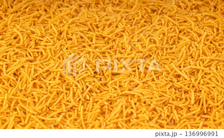 Aloo bhujia indian snack isolated. Crispy potato and chickpea flour strips, alu bhujiya sev Aloo bhujia indian snack isolated. Crispy potato and chickpea flour strips, alu bhujiya sev 136996991