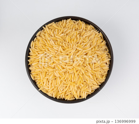Raw orzo pasta, risoni or kritharaki pile Raw orzo pasta, risoni or kritharaki pile 136996999