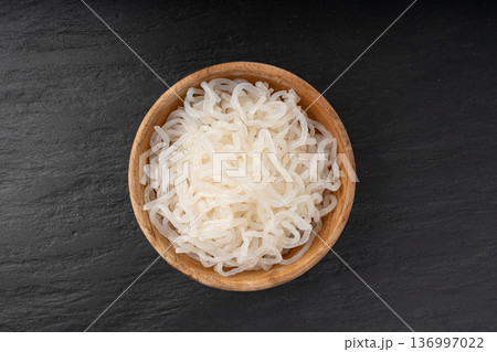 Shirataki or konnyaku pasta in wood bowl. Konjak jelly noodles, Japanese zero calorie sirataki Shirataki or konnyaku pasta in wood bowl. Konjak jelly noodles, Japanese zero calorie sirataki 136997022