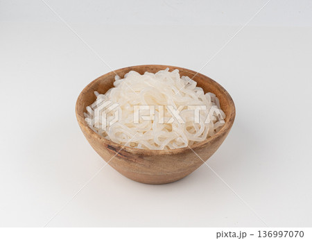 Shirataki or konnyaku pasta in wood bowl isolated. Konjak jelly noodles, Japanese zero calorie sirataki Shirataki or konnyaku pasta in wood bowl isolated. Konjak jelly noodles, Japanese zero calorie sirataki 136997070