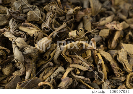 Green tea leaves macro textured background 136997082