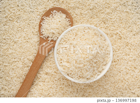 Grated coconut powder. Dry coco flakes pile, shredded desiccated coconut, tropical fruit chips 136997198