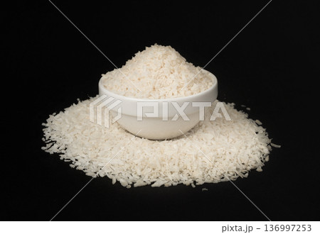 Grated coconut powder. Dry coco flakes pile, shredded desiccated coconut, tropical fruit chips 136997253