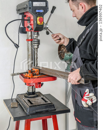 Drilling hole in metal profile 136997402