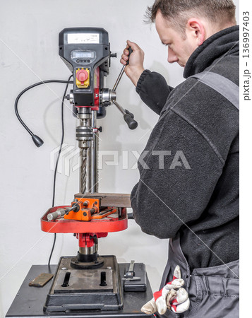 Drilling hole in metal profile Drilling hole in metal profile 136997403