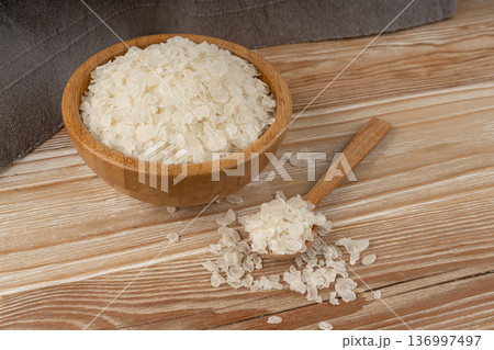 Raw flattened rice. Dry rice flakes or poha, Indian breakfast food Raw flattened rice. Dry rice flakes or poha, Indian breakfast food 136997497