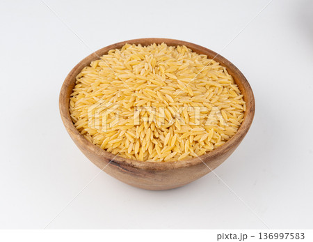 Raw orzo pasta, risoni or kritharaki pile 136997583