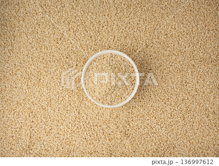 Sesame seeds pile closeup, white small benne grains. Sesamum indicum fruits 136997612