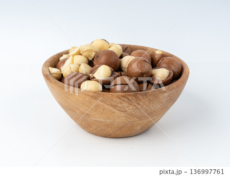 Macadamia nuts isolated. Natural raw peeled macadamia seeds and shells Macadamia nuts isolated. Natural raw peeled macadamia seeds and shells 136997761