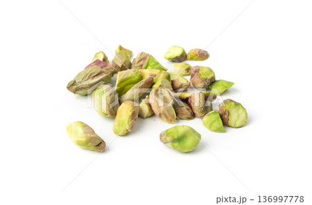 Fried salt pistachio nuts isolated. Baked pistachios pile, roasted green pistache fruits on white Fried salt pistachio nuts isolated. Baked pistachios pile, roasted green pistache fruits on white 136997778
