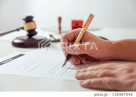 Notary signs legal contract close up Notary signs legal contract close up 136997848