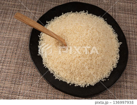 White parboiled rice grains. Dry uncooked ponni rice, small organic basmati White parboiled rice grains. Dry uncooked ponni rice, small organic basmati 136997938