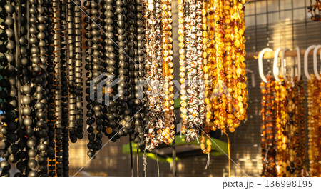 Amber stones market, polished orange gemstones closeup, natural Baltic amber gems jewelry store 136998195