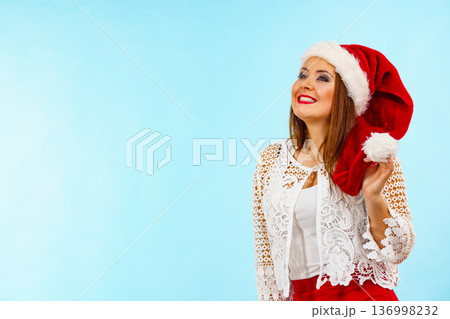 Smiling woman in christmas santa hat Smiling woman in christmas santa hat 136998232