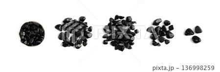 Black onyx pebbles isolated, polished hematite gem stones 136998259