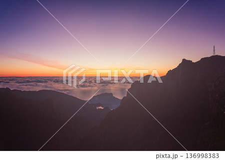 Film style sunrise panorama from Miradouro do Pico do Arieiro Madeira, pastel sky and cloud sea glow 136998383