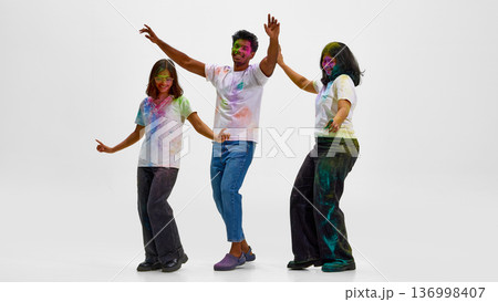 Friends expressing cultural identity through Holi festival dance. Friends expressing cultural identity through Holi festival dance. 136998407