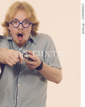 Gamer man holding gaming pad Gamer man holding gaming pad 136998427