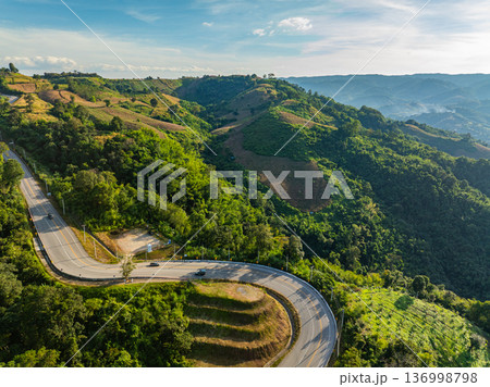 Aerial Landscape of a Winding Road Flowing Through Green Mountain Hills Aerial Landscape of a Winding Road Flowing Through Green Mountain Hills 136998798