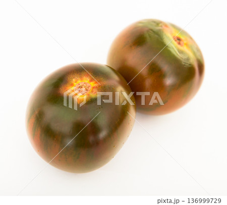 ripe black tomatoes on a white background ripe black tomatoes on a white background 136999729