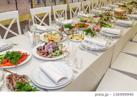 Festive table setting with salads and dishes Festive table setting with salads and dishes 136999940