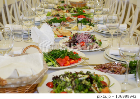 Festive table setting with salads and dishes Festive table setting with salads and dishes 136999942
