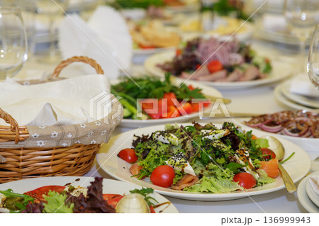 Festive table setting with salads and dishes 136999943
