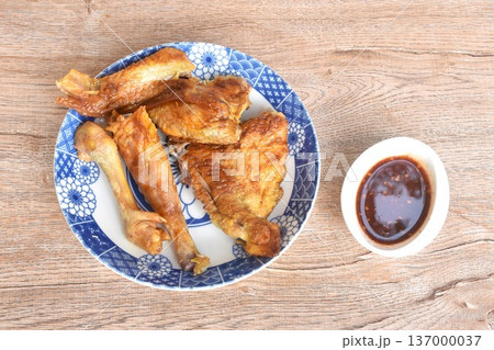grilled chop chicken meat wing and leg on plate dipping with sweet and spicy sauce grilled chop chicken meat wing and leg on plate dipping with sweet and spicy sauce 137000037