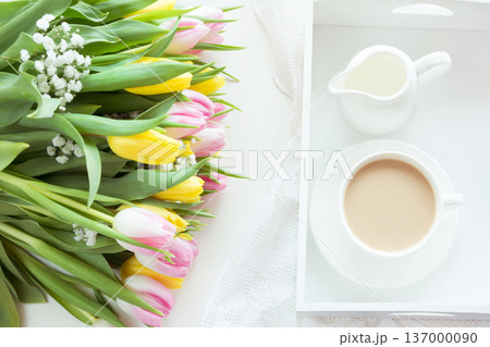 Spring morning breakfast, coffee, milk jug and cake with decor of pink hyacinth. 137000090