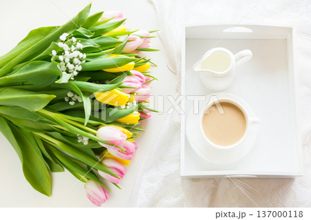 Spring morning breakfast, coffee, milk jug and cake with decor of pink hyacinth. 137000118