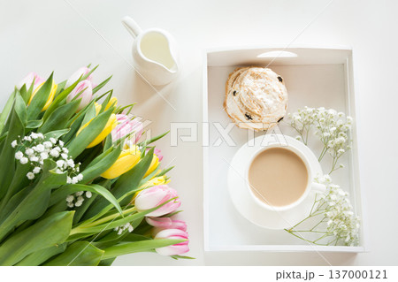 Spring morning breakfast, coffee, milk jug and cake with decor of pink hyacinth. 137000121