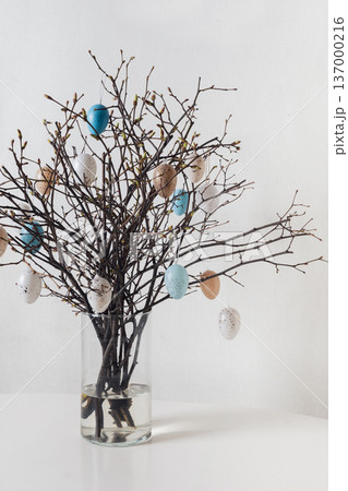 Easter branches with hanging eggs on white background Easter branches with hanging eggs on white background 137000216