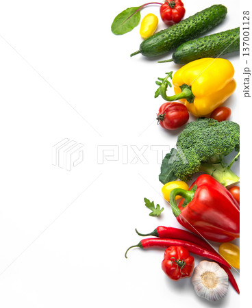 Fresh organic healthy vegetables forming colorful border on white 137001128