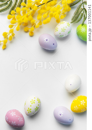 Easter eggs with mimosa flowers on white background Easter eggs with mimosa flowers on white background 137001141