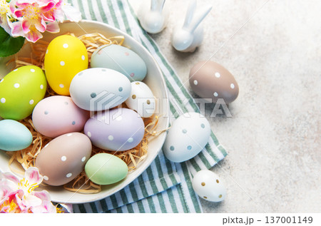 Pastel easter eggs in nest with spring decoration Pastel easter eggs in nest with spring decoration 137001149