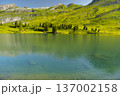 Discover the beauty of Engstlensee Lake in Switzerland. Clear waters reflect surrounding mountains and greenery, showcasing a serene natural landscape. Travel destination and popular trail. 137002158