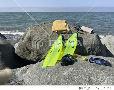 diving  equipment lies on a rock near the beach 137003061