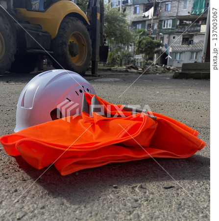 helmet and protective vest on th esidewalk. 137003067