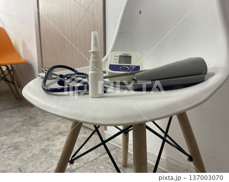 Medical tools are placed on a chair in a room with bright colors Medical tools are placed on a chair in a room with bright colors 137003070