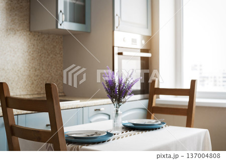 Cozy Modern Kitchen Interior with Dining Table and Natural Window Light Cozy Modern Kitchen Interior with Dining Table and Natural Window Light 137004808