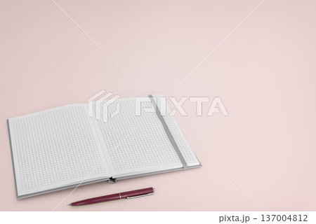 Open notebook with pen on pink background Open notebook with pen on pink background 137004812