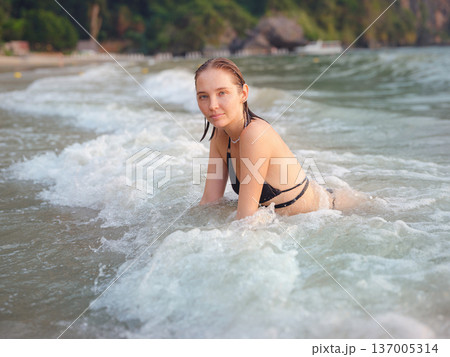Young woman enjoying serene evening at sea in Krabi, Thailand 137005314