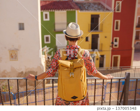 Woman strolls through colorful streets of Spanish coastal town 137005348