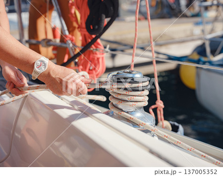 Close Up Hands Handling Yacht Ropes And Winch Equipment 137005352