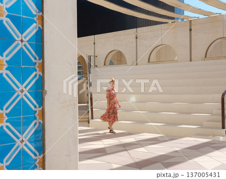 Young female tourist exploring iconic landmarks of the United Arab Emirates. Young female tourist exploring iconic landmarks of the United Arab Emirates. 137005431