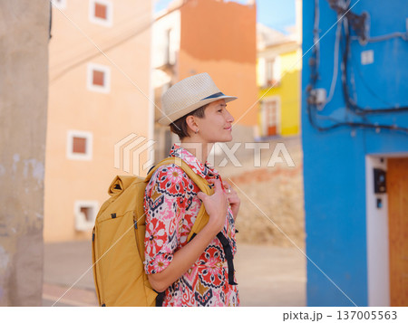 Woman strolls through colorful streets of Spanish coastal town 137005563