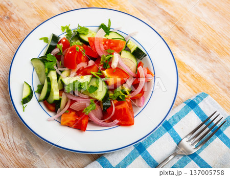 Fresh salad with cucumbers, tomatoes and onion 137005758