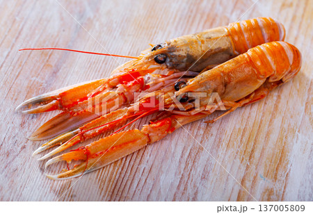 Raw Norway lobster on wooden table Raw Norway lobster on wooden table 137005809