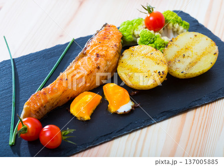 Roasted salmon and potatoes with egg yolk 137005885