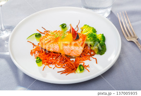 Delicious roasted salmon on smoked carrots Delicious roasted salmon on smoked carrots 137005935